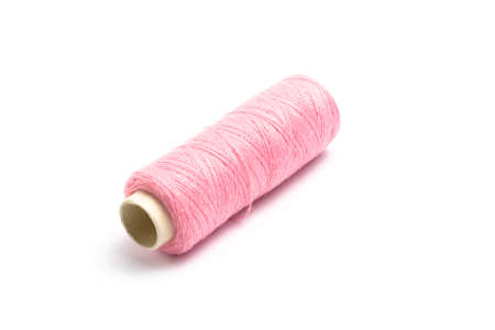 Thread with a needle on a white background. close up