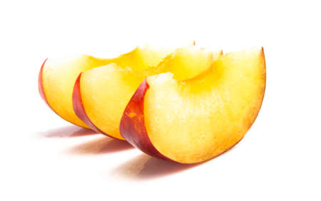 Ripe red plum in a cut on a white background. close upの写真素材