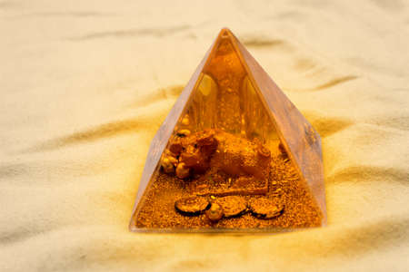 Gold epoxy pyramid with coins and bull