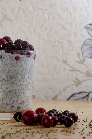 healthy breakfast of chia yogurt seeds and wild berries on a wooden background fitness food. copy spaceの写真素材