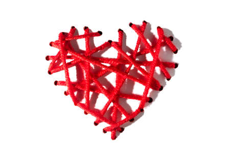 Heart of red embroidery threads with hard shadows for Valentine's Day on a white background. isolateの写真素材