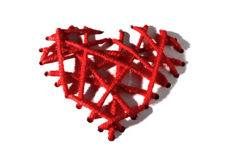 Heart of red embroidery threads with hard shadows for Valentine's Day on a white background. isolate