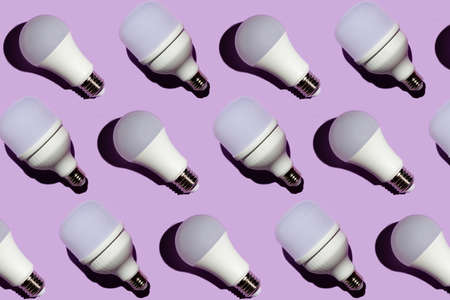 Pattern of led light bulbs with hard shadows on a purple backgroundの写真素材