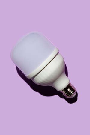 LED light bulb with hard shadows on a purple backgroundの写真素材