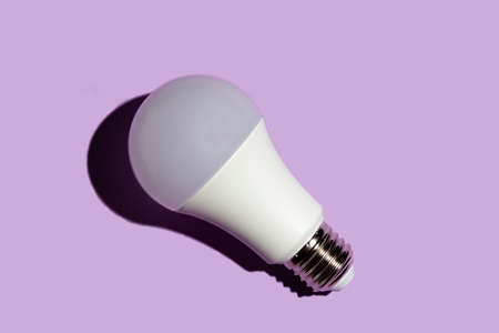 LED light bulb with hard shadows on a purple backgroundの写真素材