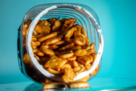 cookies in a jar in the form of a figure star triangle oval heart on teal background. close-up. copy spaceの写真素材