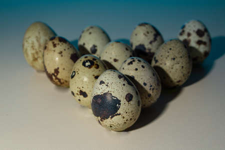 triangle quail eggs for billiards, bowling, blue background, close-up, copy space
