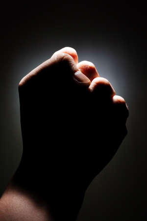 male fist  strength on a dark background isolate. copy space close upの写真素材