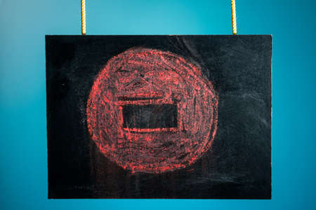 Chalk board is suspended with a pattern of red stop sign on a blue background. copy spaceの写真素材