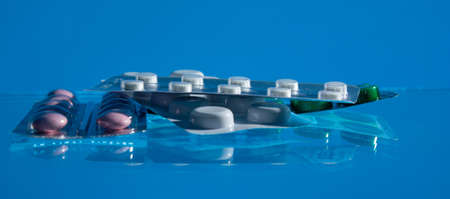 pills medicines, medicine on glass blue background close up. copy spaceの写真素材