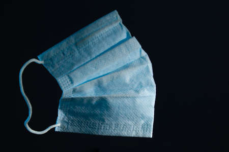 blue medical gauze mask on a dark background copy space. close upの写真素材