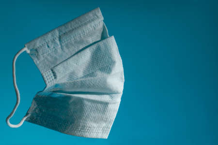 blue medical gauze mask on a blue background copy space. close up