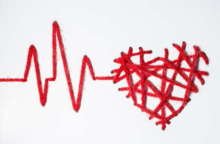 heart with pulse with drops made of red thread Valentine's Day love on a white background. copy spaceの写真素材