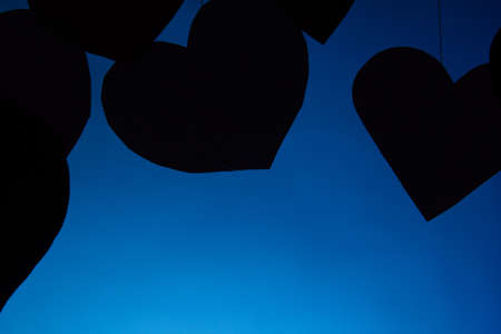 Signs, hearts on a rope Valentine's Day love on a blue background. Close copy space