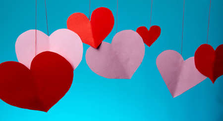 hearts red and pink on a string Valentine's Day love on a blue background. close copy spaceの写真素材