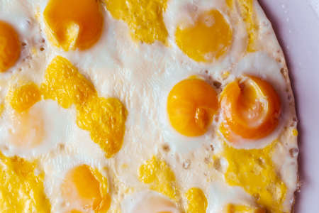 fried eggs of quail eggs in the shape of a circle on a white background. close up copy spaceの写真素材