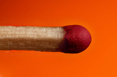 match with a red head on a Lush Lava background. close up copy spaceの写真素材