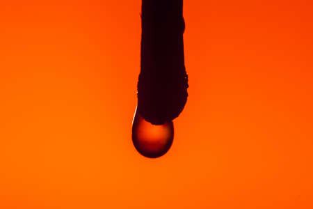 Burned match in the coals with a drop of water on Lush Lava background. close up copy spaceの写真素材