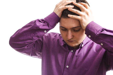 overweight man in violet takes up his head with two hands problem on a white background copy space...