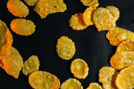 Corn flakes breakfast with orange modeling light on black background copy space close upの写真素材
