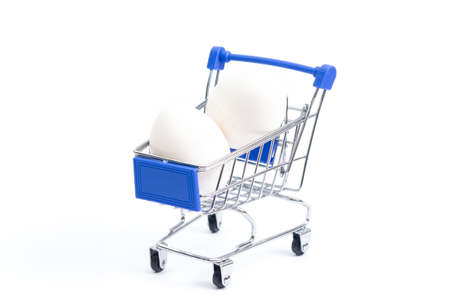 shopping cart with white chicken eggs on a white background. isolateの写真素材