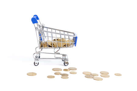shopping cart with coins falling on a white background.の写真素材