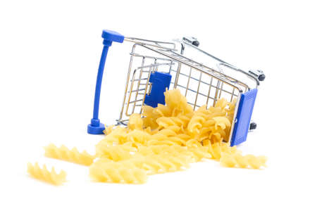 fallen shopping cart with swirling pasta on a white background. isolateの写真素材
