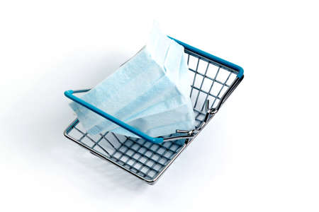 shopping basket with coronavirus medical mask on a white background, isolateの写真素材