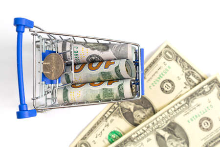shopping cart with blue inserts with a roll of hundred-dollar banknotes and a quarter of a dolar on...