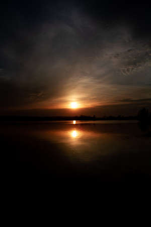 sunset over the river in a dark keyの写真素材