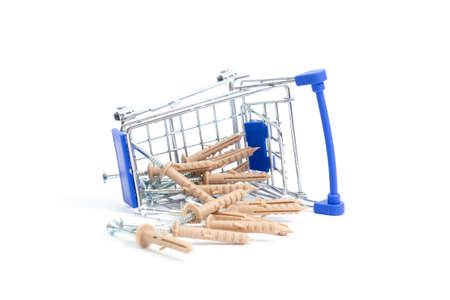 fallen shopping cart with screws for the wall on a white background. isolate, side view