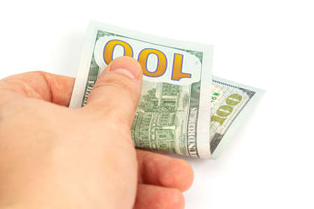 hand holds out hundred dollar bills on a white background. isolate. close up