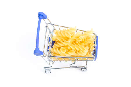 shopping cart with swirled pasta on a white background. isolateの写真素材