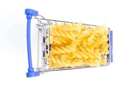 shopping cart with swirled pasta on a white background. isolate, top viewの写真素材