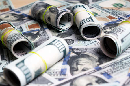 hundred dollar bills and rolls of banknotes. view from above. to closeの写真素材