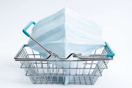shopping basket with coronavirus medical mask on a white background, isolate