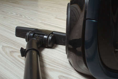 black vacuum cleaner on a light floorの写真素材
