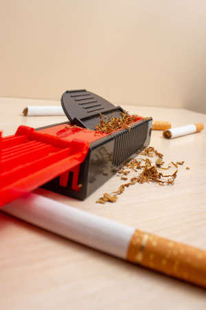 typing machine and cigarettes in the background on a light woodenの写真素材