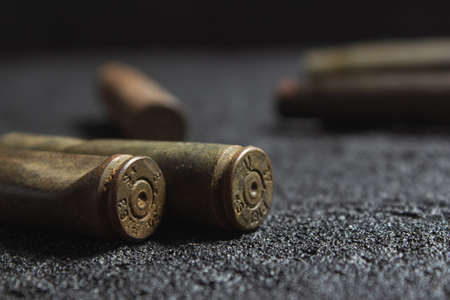 old rusty spent shells on black concreteの写真素材