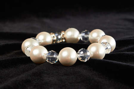 bracelet from pink Mallorca pearls semiprecious stone on black velor. close upの写真素材
