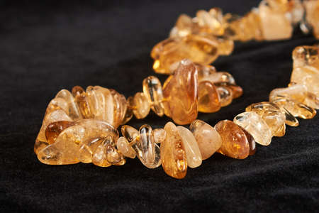 beads from amber semiprecious stone on black velor. close upの写真素材