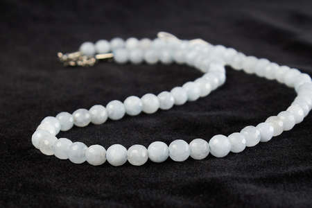 beads from aquamarine semiprecious stone on black velor. close upの写真素材