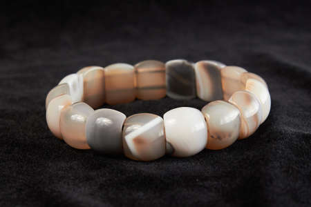 bracelet from carnelian semiprecious stone on black velor. close upの写真素材