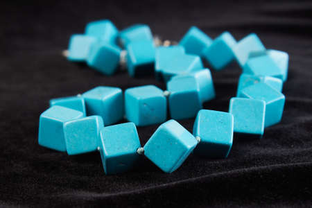 beads from turquoise semiprecious stone on black velor. close upの写真素材