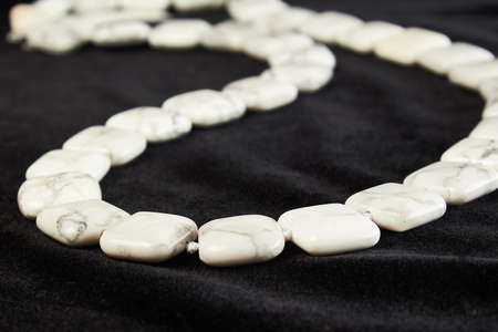 beads from agate semiprecious stone on black velor. close upの写真素材