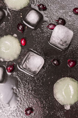 melted ice with berries on a black table freshness. close up, flat lay