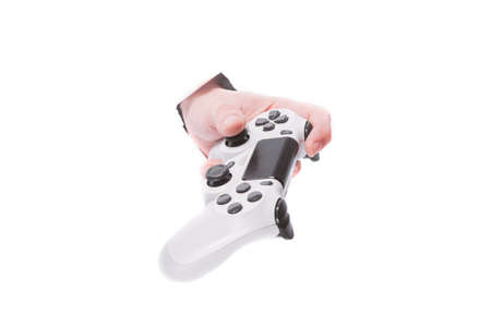 male hand with a gamepad through a hole in paper on isolate white background. close copy space
