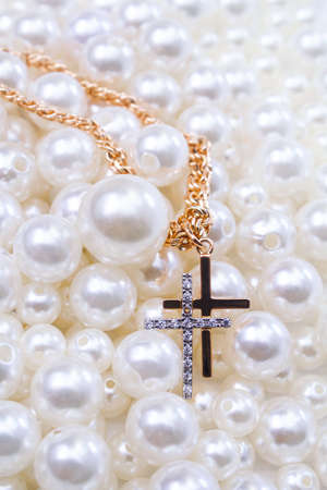 gold chain with crosses one in diamonds on pearl beads