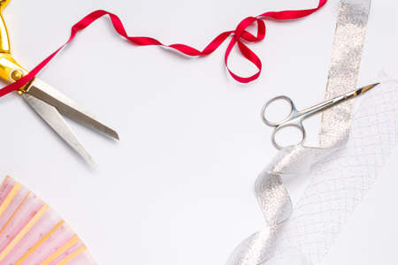 needlework golden scissors ribbons fan on a light background copy space. top view, frameの写真素材