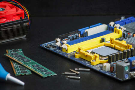 computer motherboard two RAM slots, cooler, processor on the table repair equipment